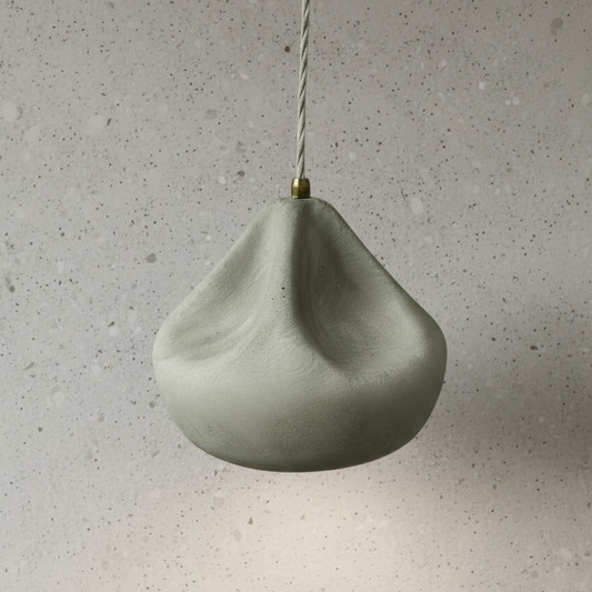 Green ceramic pendant light on a gray speckled background