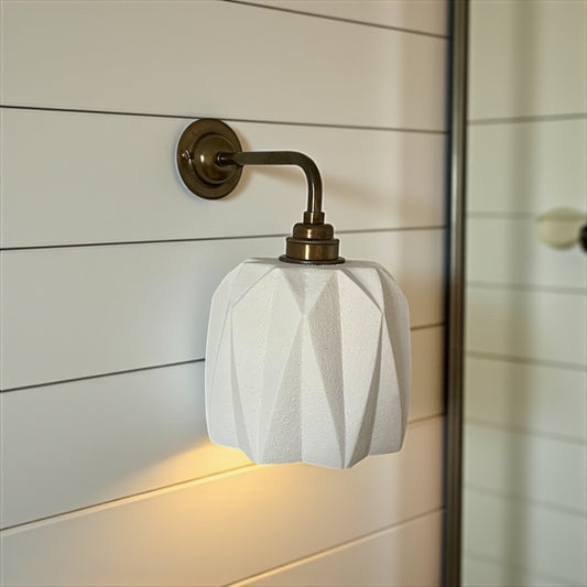 handmade Wall-mounted light fixture with geometric white shade on a wooden panel background