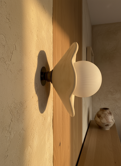 Decorative wall sconce with a soft glow on a textured wall.
