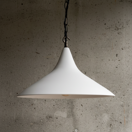 White pendant lamp hanging against a textured concrete wall