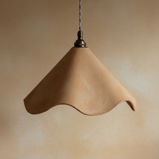 Beige pendant lamp hanging above a wooden surface with a plain background