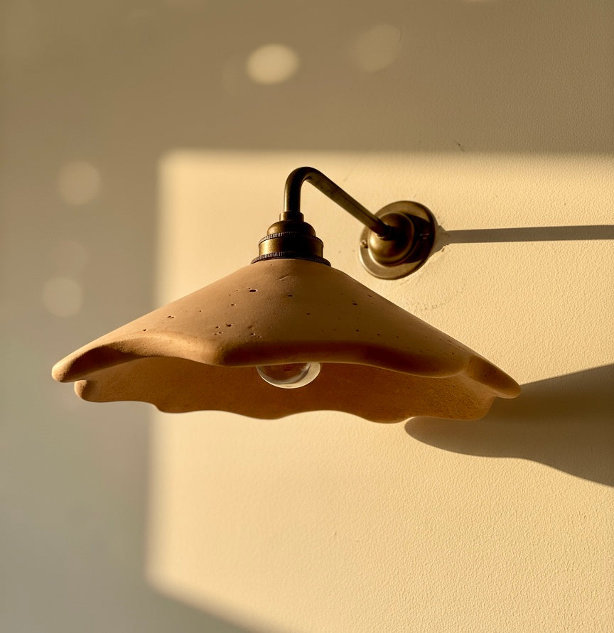 Plaster wall sconce with a warm glow on a beige wall