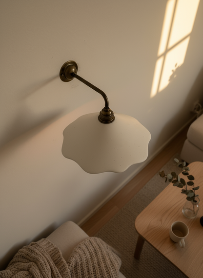 White wall sconce with a white glass shade in a cozy room.