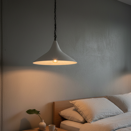 Bedroom with a plaster cone pendant light, nightstand, and bed.