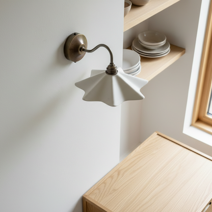 Wall-mounted lamp with a wooden cabinet and shelves in the background