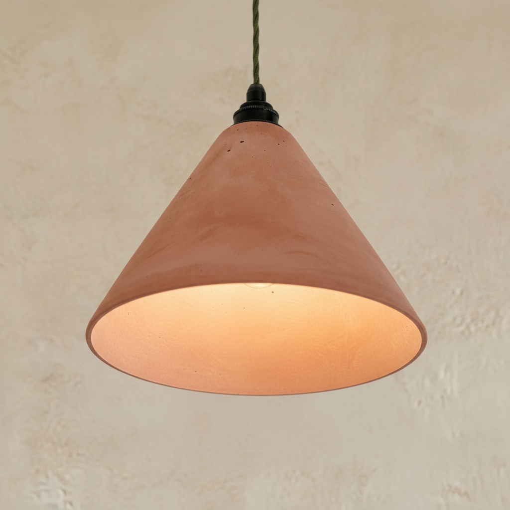 Terracotta-colored pendant light against a beige wall
