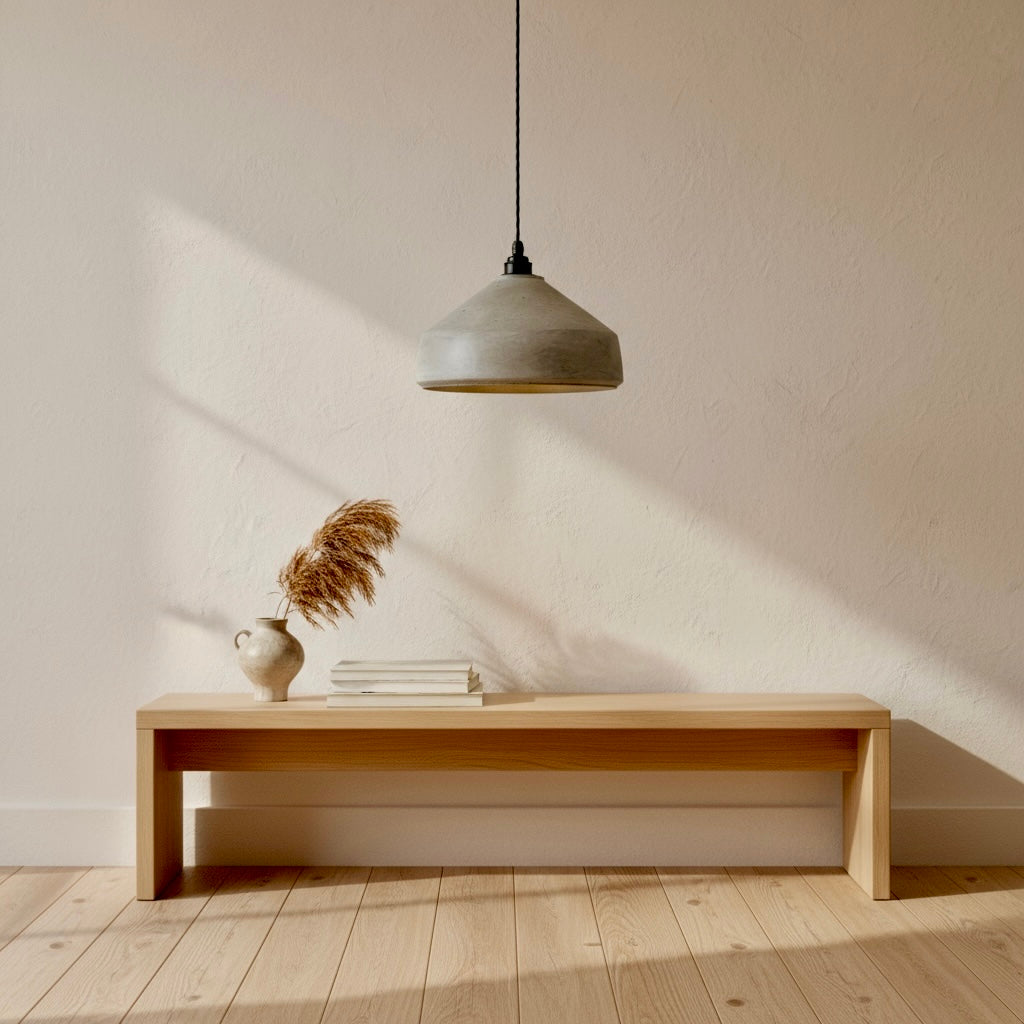 Minimalist interior with a wooden bench, vase, and handmade pendant light.