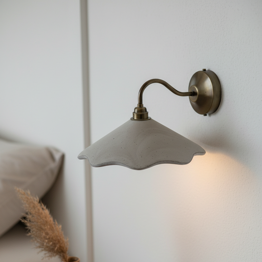Wall-mounted lamp with a soft glow in a room setting.