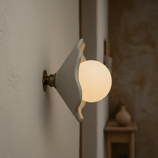 Wall-mounted light fixture with a glowing bulb on a neutral wall.