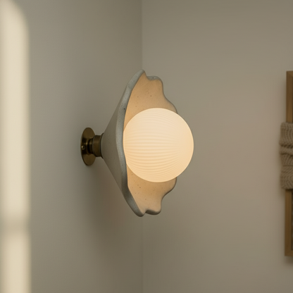 Wall-mounted light fixture with a warm glow on a neutral wall.