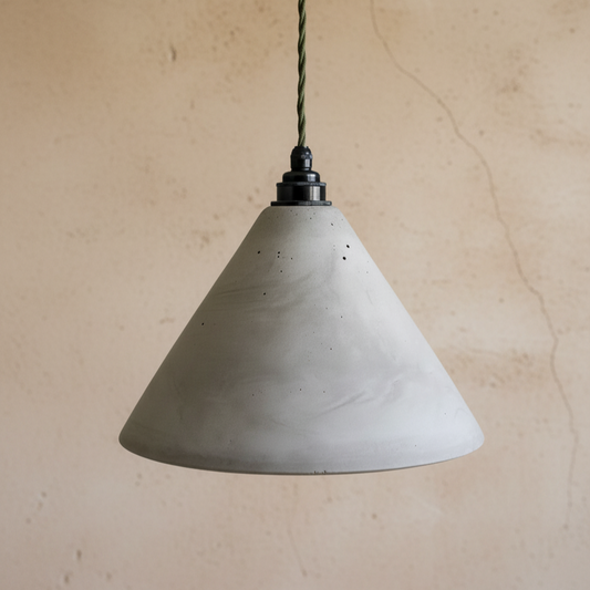 Concrete pendant light against a beige wall
