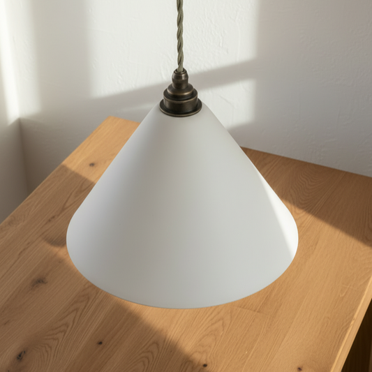 White cone-shaped lampshade on a wooden surface with a neutral background