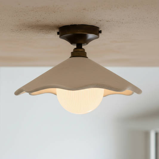 Ceiling light fixture with sandstone plaster shade on a neutral background