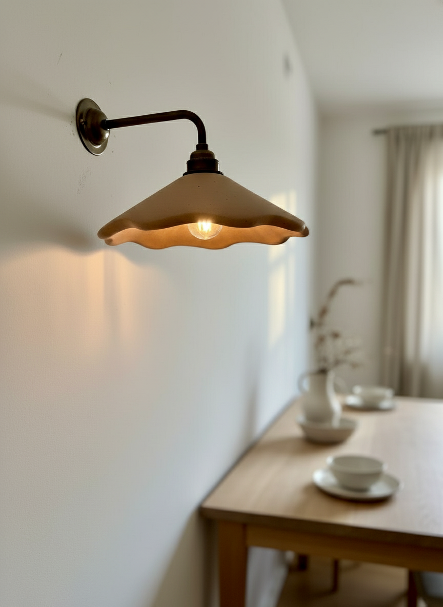 Wall-mounted light fixture casting a warm glow in a room with a wooden table and decor.