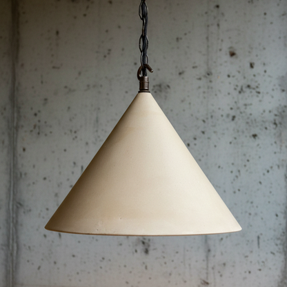Beige cone-shaped pendant light against a textured wall.