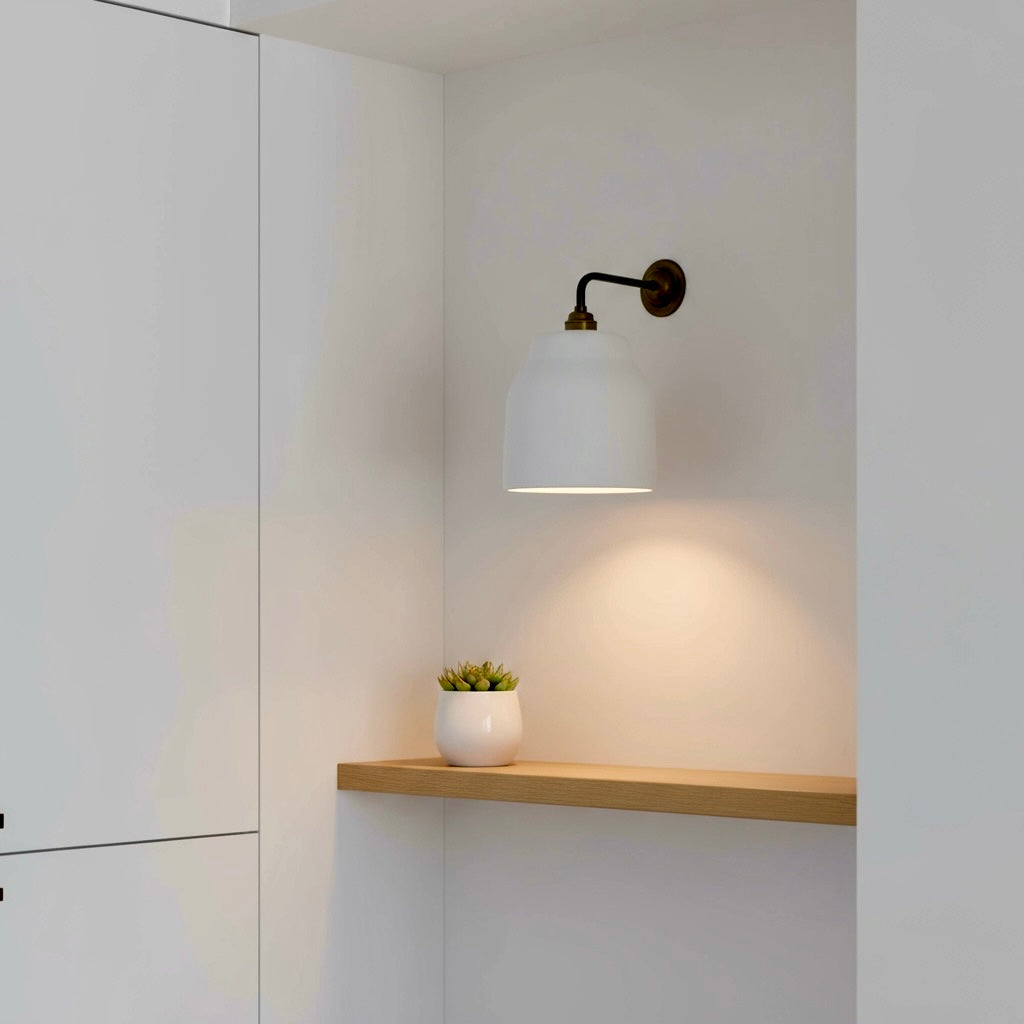Handmade wall sconce fixture with a white shade on a neutral wall.