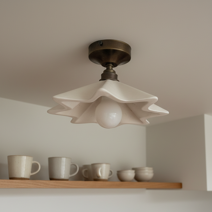 Ceiling light fixture in a kitchen with shelves displaying ceramic items.