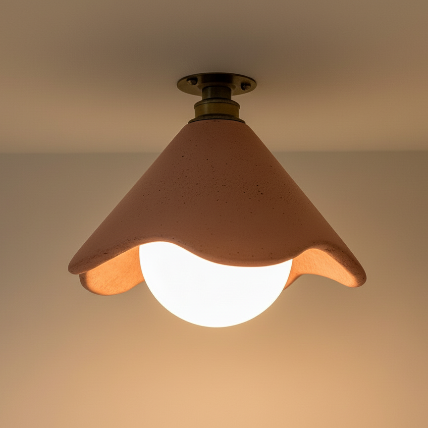 Ceiling light fixture with a terracotta shade on a neutral background