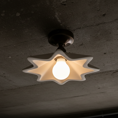 Ceiling light fixture with a star-shaped shade on a textured ceiling