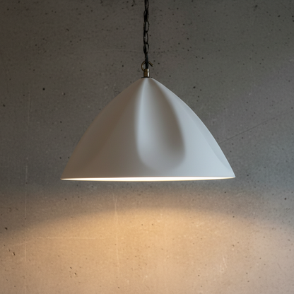 White pendant light hanging against a gray wall