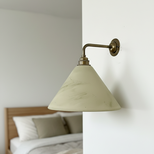 Bedroom with a wall-mounted lamp and wooden headboard