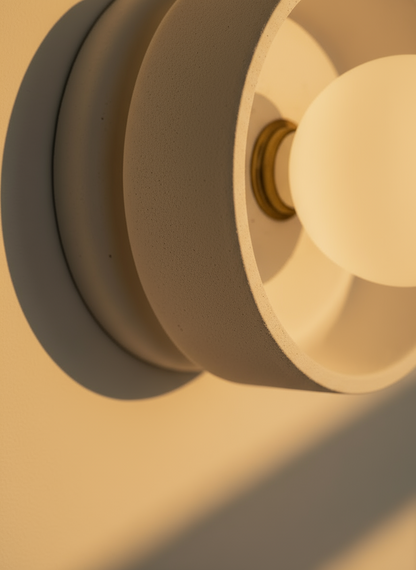 Close-up of a light fixture with a warm glow on a beige background