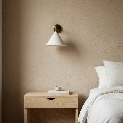 Bedroom with wooden nightstand, white lamp, and beige wall