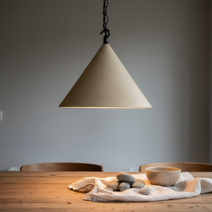 Beige pendant light hanging above a wooden table with a bowl and stones on a gray background