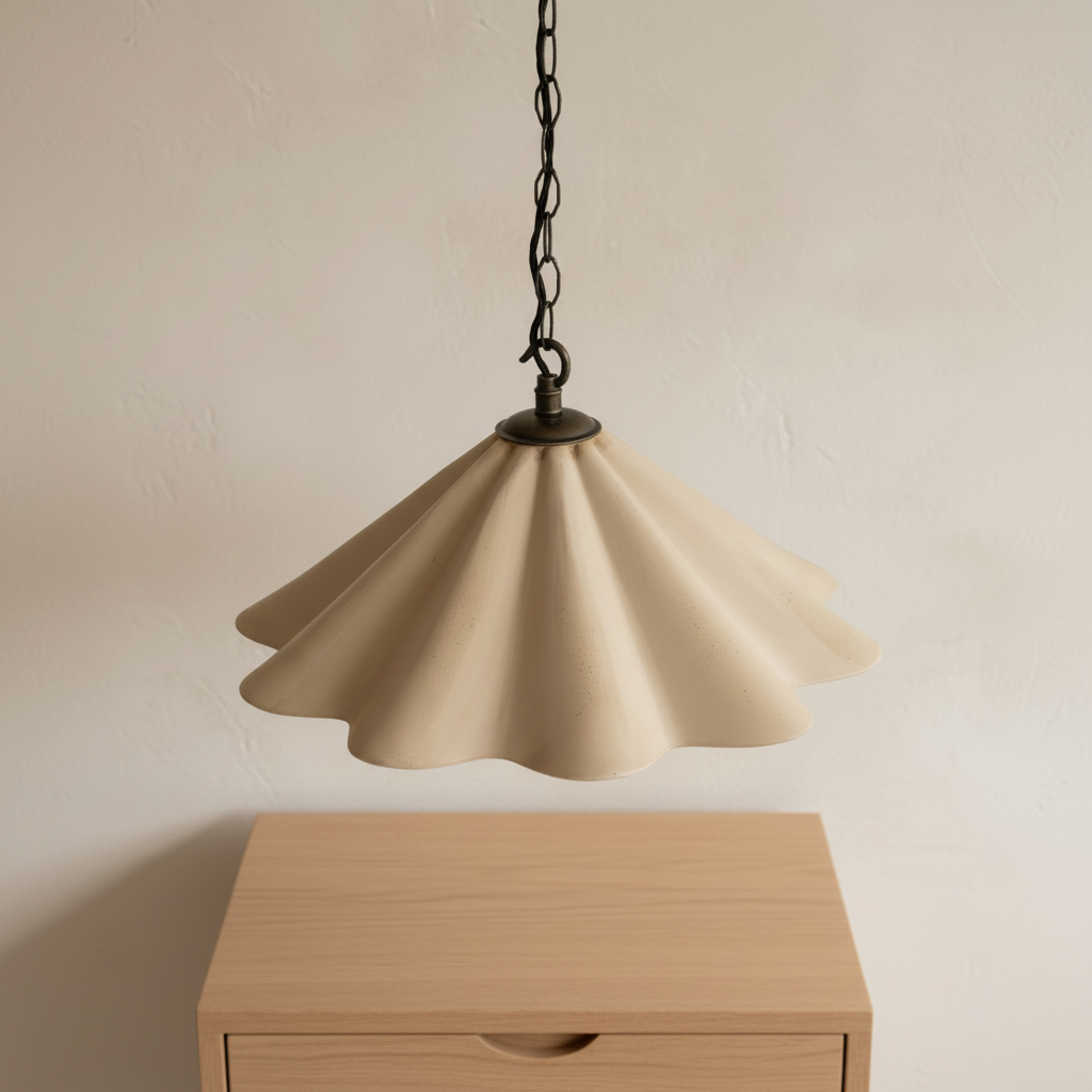 Sandstone pendant lamp hanging above a wooden table against a beige wall