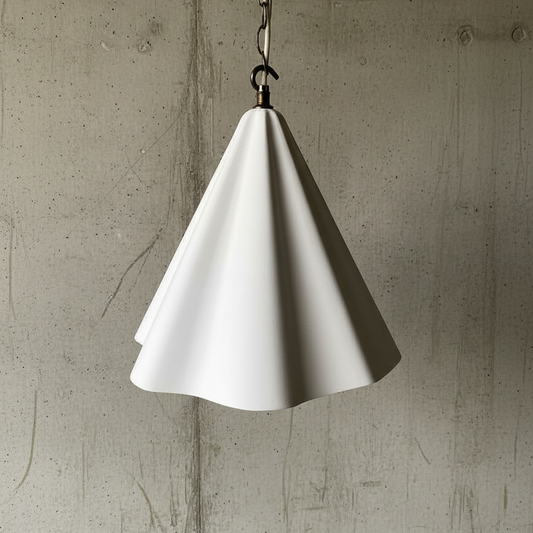 White cone-shaped pendant light against a textured concrete wall