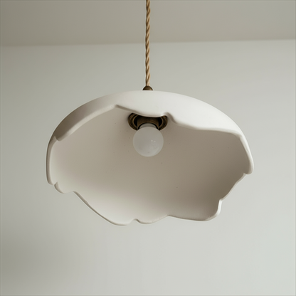 Handcrafted pendant light with a floral design on a plain background