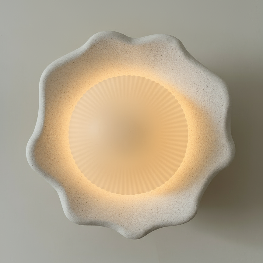 Decorative wall light with a floral design on a plain background