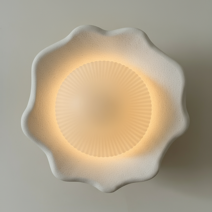 Decorative wall light with a floral design on a plain background