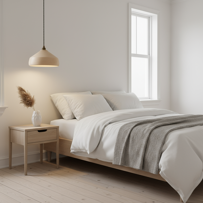 Modern bedroom with a bed, nightstand, and minimalist pendant light.